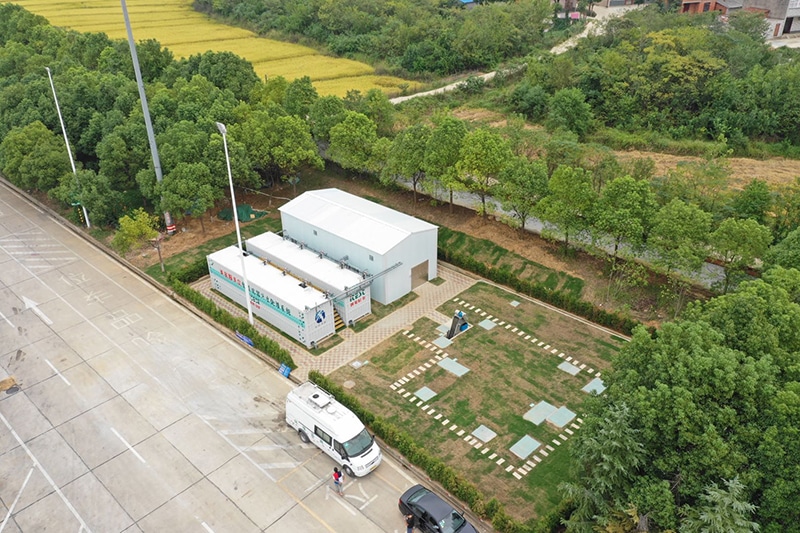 Fluence Aspiral™ Flex containerized wastewater treatment system in a wooded area