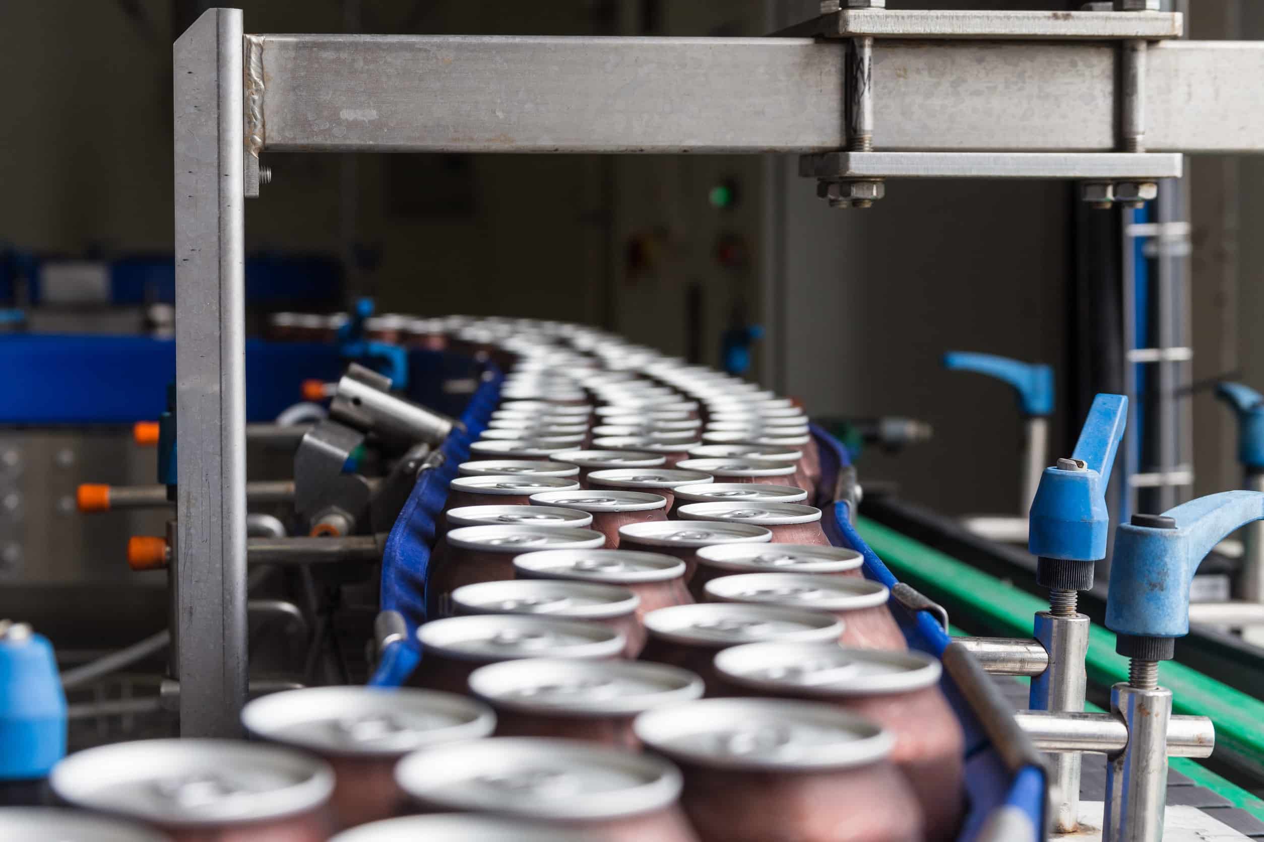 Cans Move Along a Conveyor Belt in Brewery